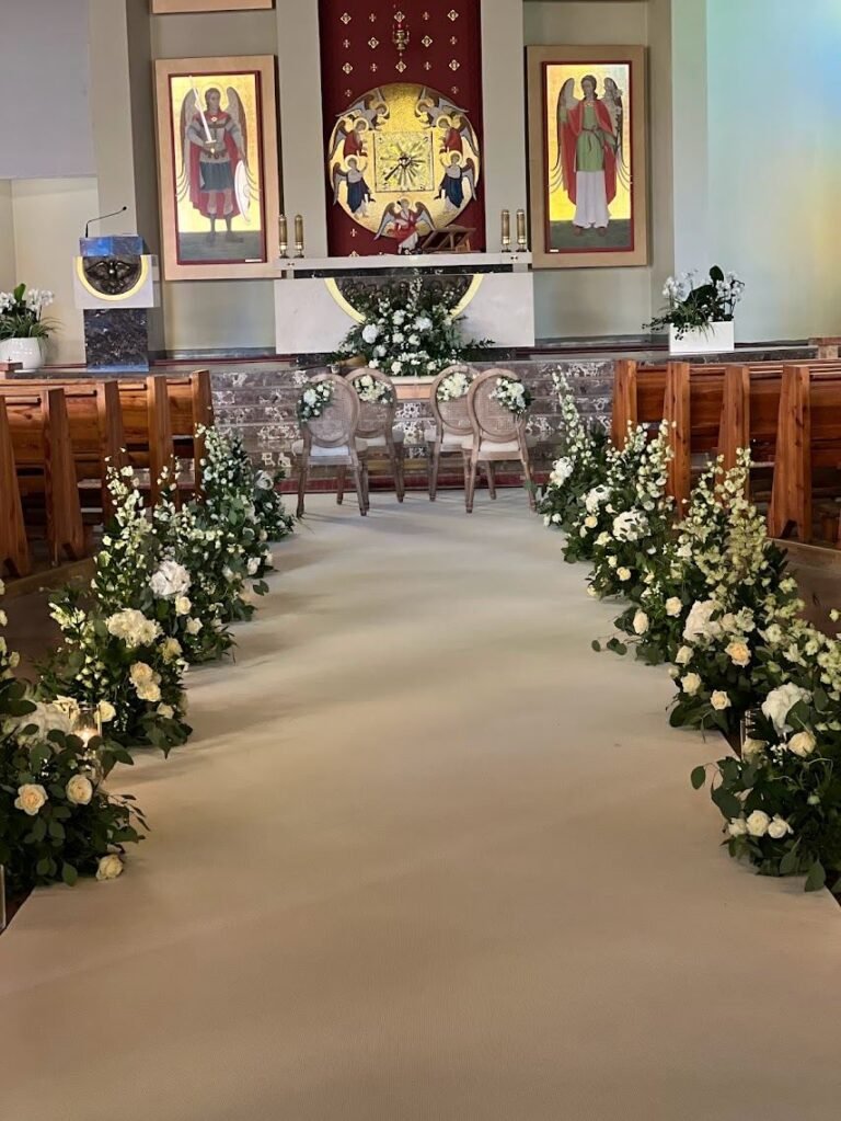The aisle in the church decorated with flowers — OIA Decorations